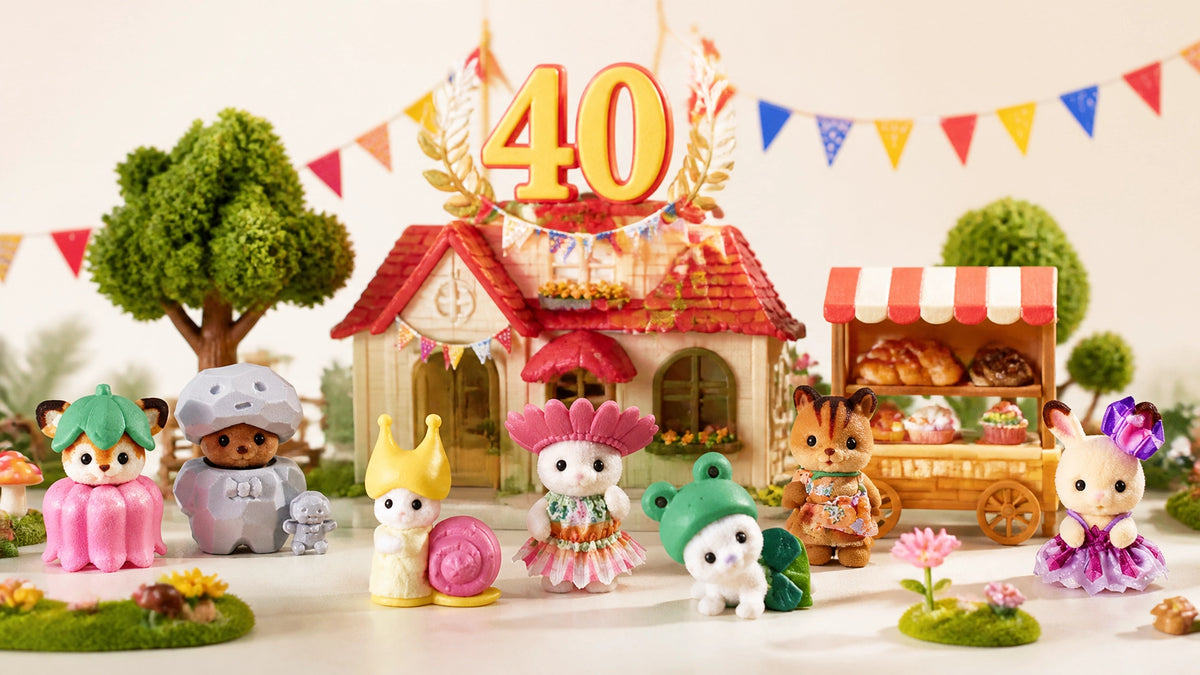 A charming Sylvanian Families-inspired woodland village display with flocked animal figures, a tiny cottage and 40th annivers